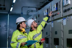 engineer checking and inspecting at MDB panel working with electric switchboard to check range of vo